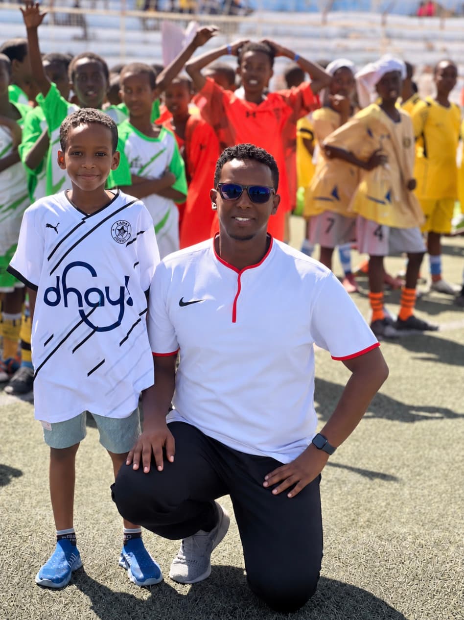 Deeq Afrika with a young footballer