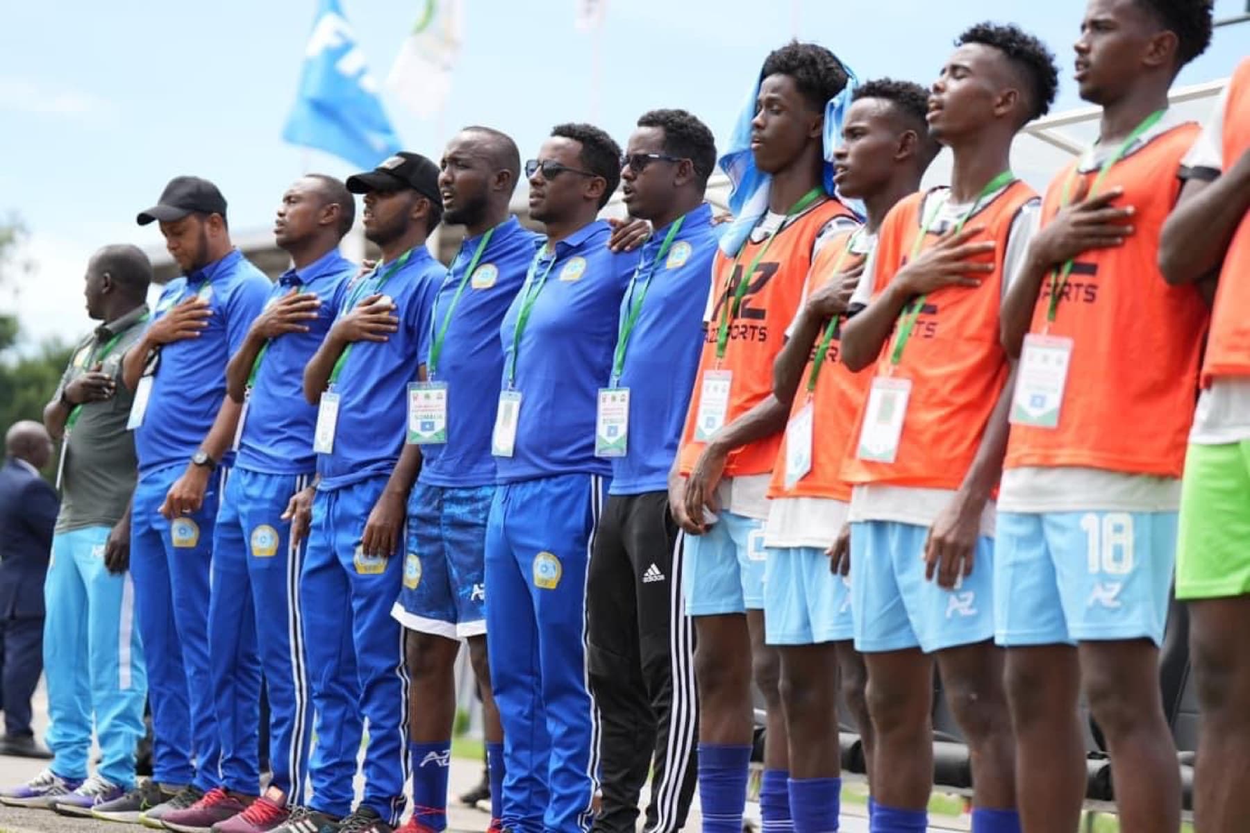 Somalia players and staff standing for the national anthem