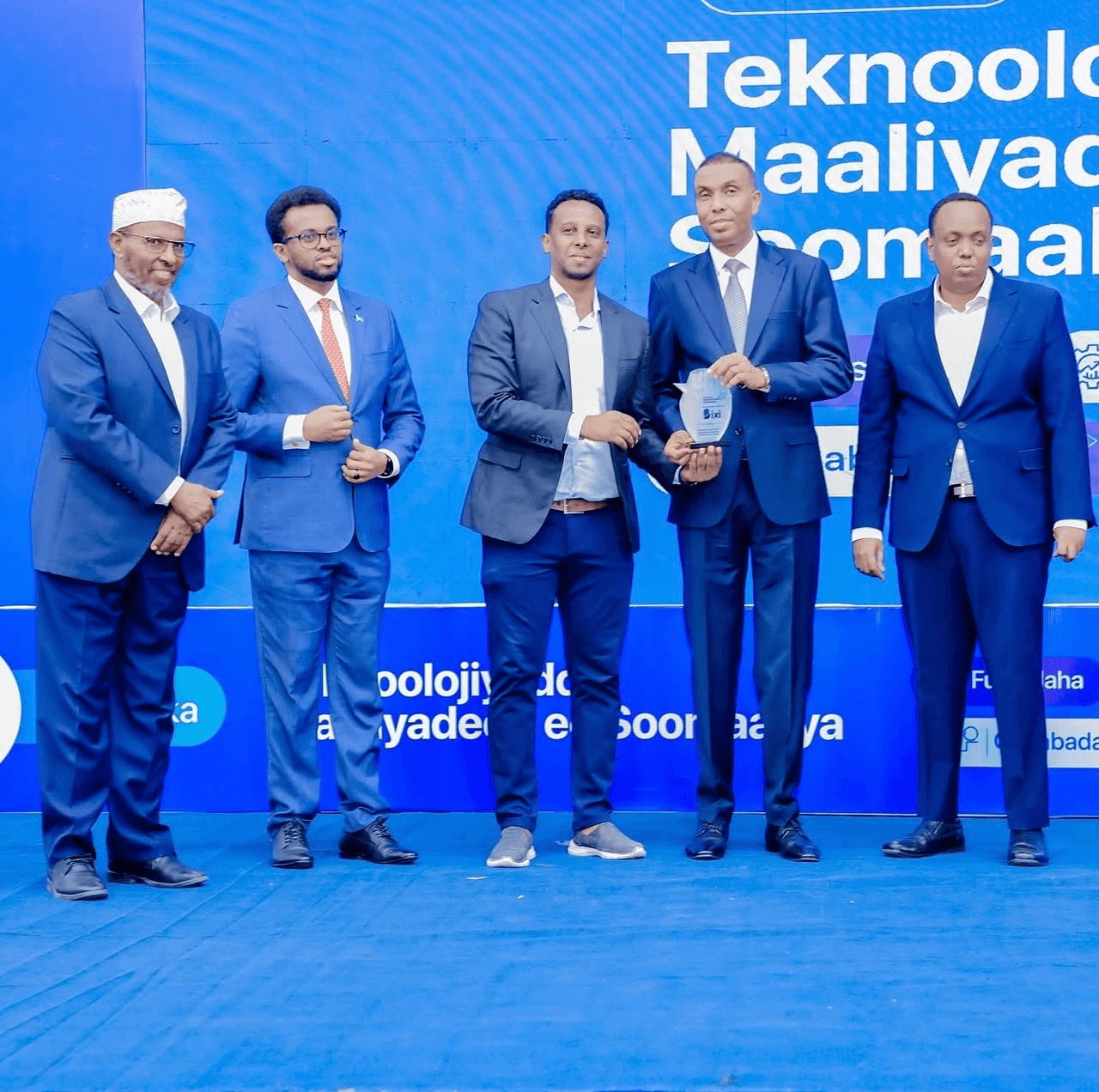 Deeq Afrika taking part in an award presentation at a business event